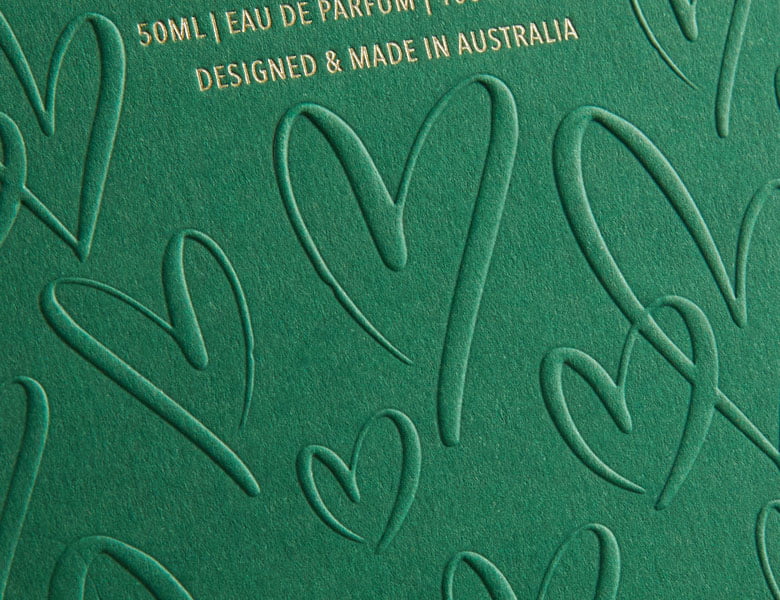Raised embossing detail on premium paper packaging